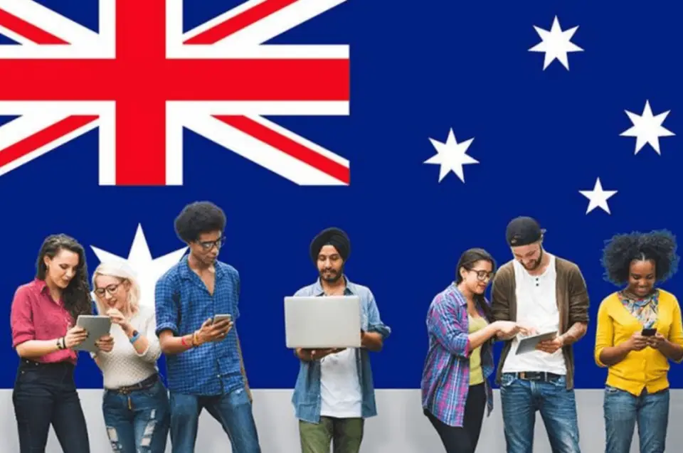 International students gathered in front of the Australian flag