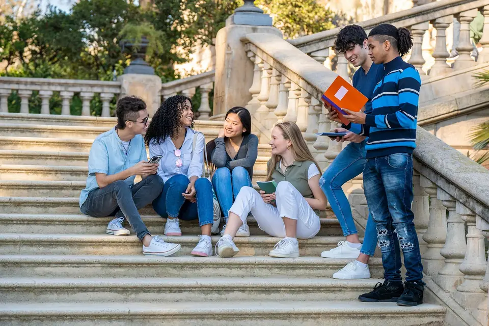 Students sitting together on university steps in Europe