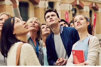 Group of young people looking up excitedly