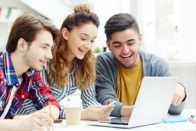 Students preparing for exams together on a laptop